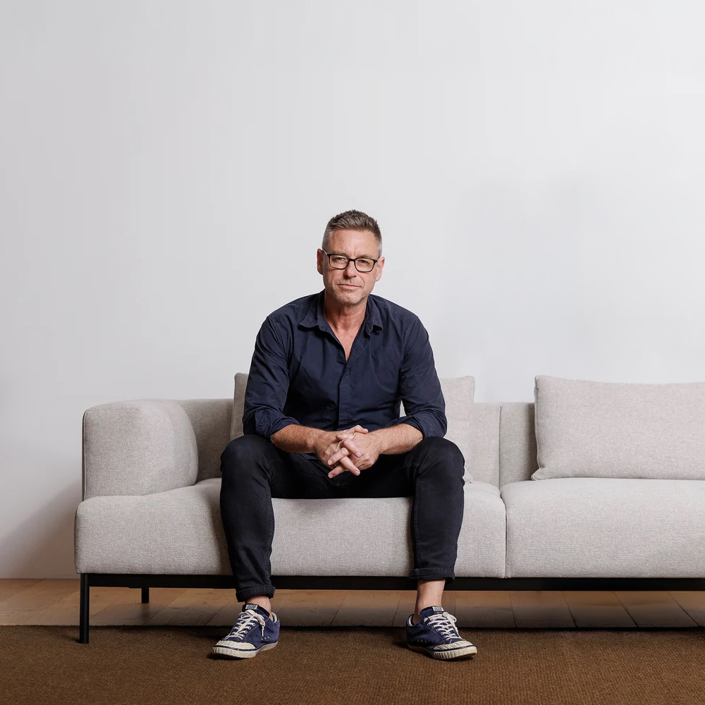 Cameron Foggo seated on the Basel sofa for Citta 2025